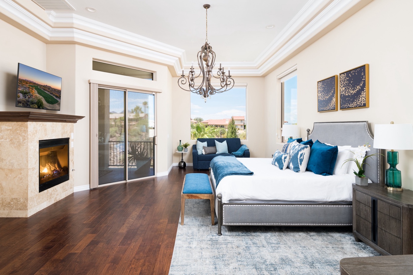 Master bedroom with TV, fireplace, balcony access