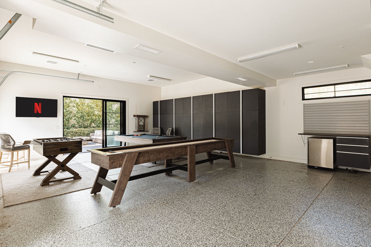 Game room with Pool table, ping pong, shuffleboard, foosball and TV!
