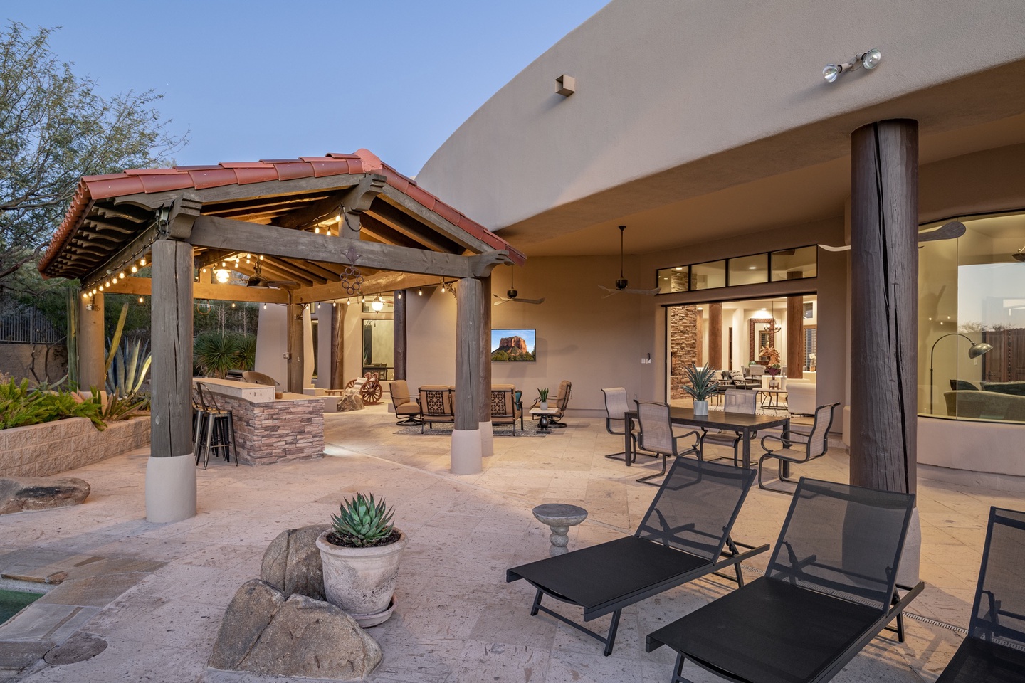 Large covered patio with outdoor TV and plenty of seating