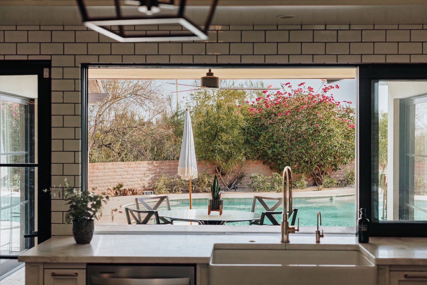 Large window connecting kitchen to backyard patio