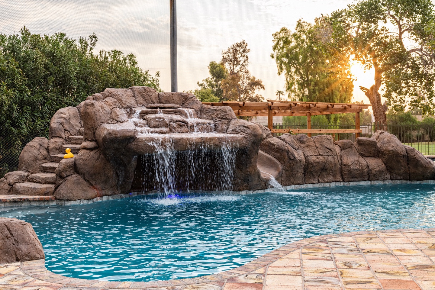 Large heated* pool with waterfall, water slide, and spa