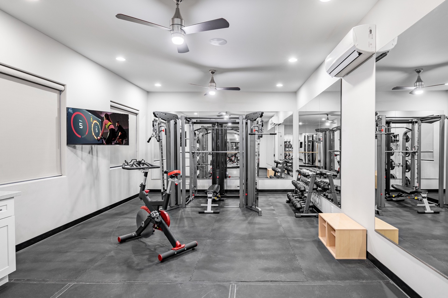 Fully equipped exercise room with wall TV and surround sound