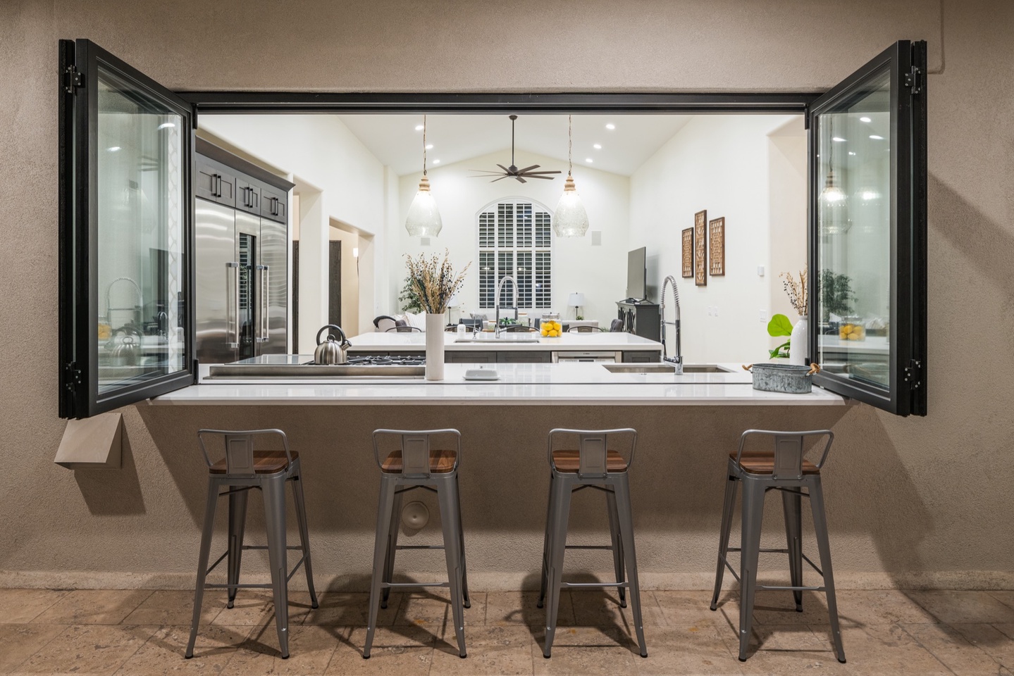 Kitchen windows open to the outside creating a great flow to the pool