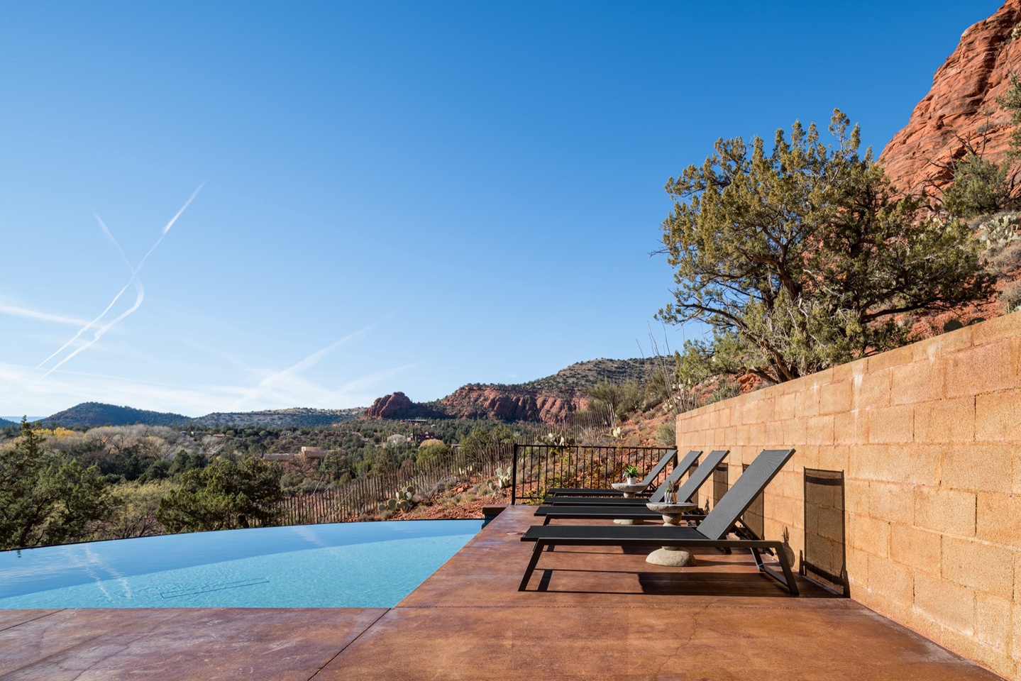 Outdoor lounge space along the heated* pool