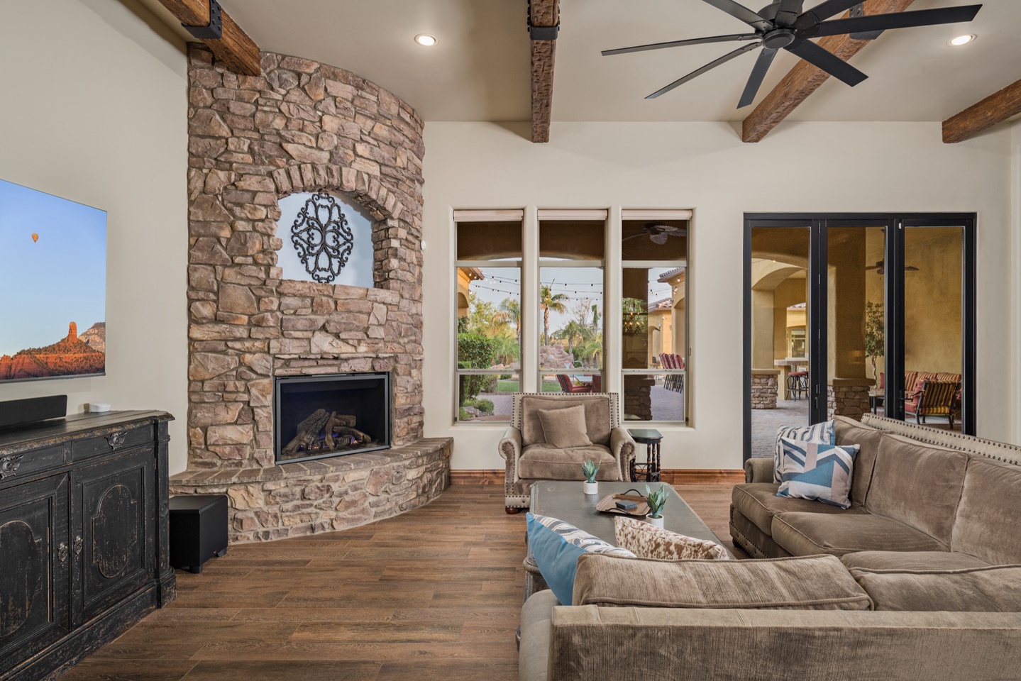 Large couch situated around the fireplace